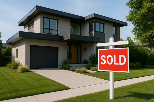 A modern house with the sign "SOLD" in the front